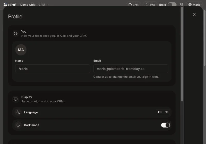 Profile open over the CRM, with Name, Email, Language and Dark mode